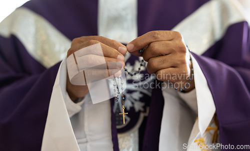 Image of Priest, pastor and man hands with rosary with cross in church, prayer and catholic worship, praying or spiritual respect. Christian preacher, faith beads with crucifix and holy religion for God mercy