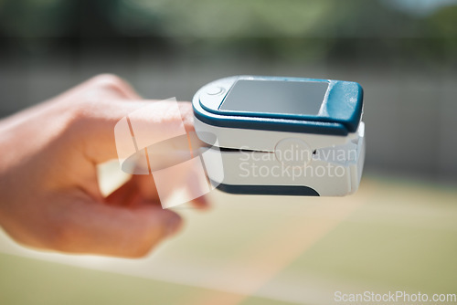 Image of Hand, health and pulse oximeter in nature for oxygen measurement. Healthcare, wellness or SPO2 meter on finger of person to check, monitor or test blood levels or heart rate outdoors at park outside