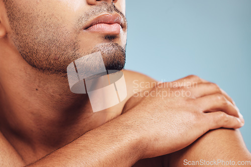 Image of Man, jaw and skincare, face grooming and beard for beauty, aesthetic wellness and healthy skin on studio blue background. Closeup of handsome guy model, facial hair and dermatology body cosmetics