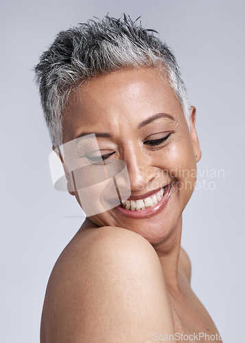 Image of Face, beauty and skincare with a senior woman in studio on a gray background for wellness or natural care. Health, cosmetics and antiaging with a mature female posing for dermatology or cosmetology