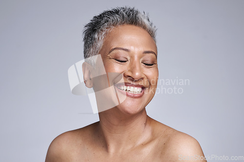 Image of Happy senior model, beauty and makeup face for cosmetics, health and skincare by studio backdrop. Elderly black woman, skin wellness and radiant cosmetic glow, anti aging and smile by grey background