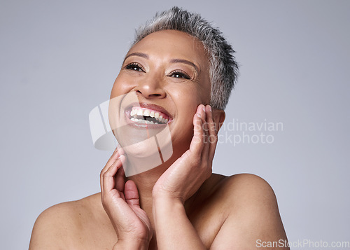 Image of Face, beauty and skincare with a senior woman in studio on a gray background happy with an antiaging treatment. Wellness, cosmetics and skin with a mature female inside to promote natural facial care