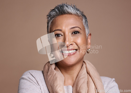 Image of Face, fashion and senior woman in studio isolated against a brown background. Beauty portrait, smile and makeup cosmetics or aesthetics of happy elderly model from India in designer scarf or clothes.