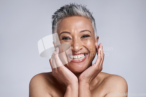 Image of Beauty, skincare and portrait of senior woman in studio on gray background. Makeup cosmetics, smile and happy mature female model from India touching face for facial or healthy skin treatment routine