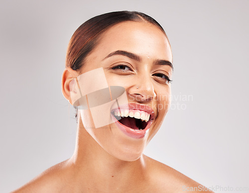 Image of Woman, face and smile with teeth for dental care, hygiene or skincare against grey studio background. Portrait of happy female smiling in satisfaction for oral cosmetics, mouth or gum care treatment