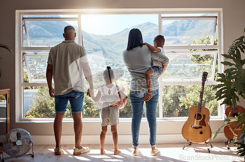 Image of Family, love and window back view in home looking at mountain. Support, trust and baby, mother and father holding hands of girl in house with scenic view, enjoying quality time together and bonding.