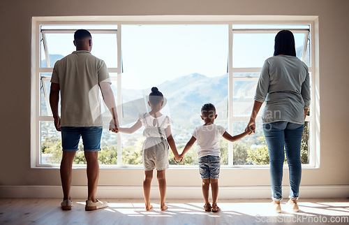 Image of Love, back view and family holding hands by window looking at scenic view of nature, trees and mountain. Bonding, affection and mom and dad standing with kids in new apartment, happy in family home