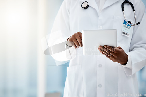 Image of Doctor, hands and tablet in hospital office for online consultation or telehealth app. Research, healthcare and black female physician on touchscreen tech, medical news or checking patient records.