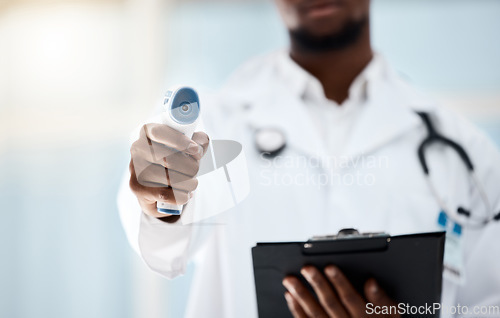 Image of Covid, temperature and clipboard with doctor measuring fever or cold with a thermometer in a hospital. Medical healthcare, covid19 measure with a clinic professional with a patient chart