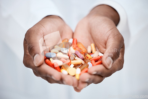 Image of Doctor, hands and pills for healthcare, medication and health recovery in a hospital or clinic. Medical expert, hand and holding medicine capsule for wellness, recovery and expert pharmacist person