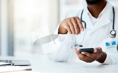 Image of Doctor, hands and phone in hospital office for telehealth, online consultation or research. Healthcare, mobile tech and black female physician on 5g smartphone, wellness app or checking medical email