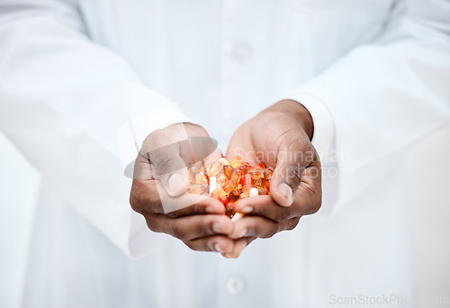 Image of Hand, pills and doctor holding medicine for cancer treatment closeup in a medical clinic. Supplements, vitamins and antibiotics capsule or pill for medicare with open hand of pharmacist