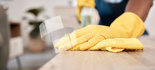 Image of Wiping, cloth and hands of a man on a table cleaning the dust with gloves in a house. Bacteria, service and cleaner with product to clean for disinfection of a surface, desk or apartment for health