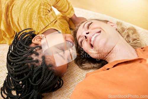 Image of Family, happiness and love after adoption of foster child while lying on the floor for love, care and trust with a smile. Face of a woman and black kid together as mother and daughter for support