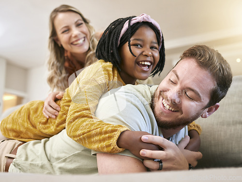 Image of Adoption, love and family play, hug and happy smile, care and laugh together on the sofa in living room. African child, mother and father with happiness, fun and laughing on the couch in family home