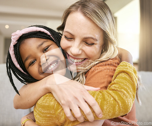 Image of Portrait, family and adoption with a girl and mother hugging in a living room of their house together. Face, love and children with a foster parent woman and daughter embracing while bonding at home