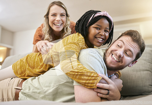 Image of Family, adoption and love with a mother, father and foster child together on living room couch for fun, happiness and bonding. Portrait, smile and trust of man, woman and girl share hug for sopport