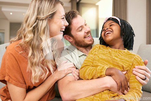 Image of Family, love and hug, laughing and happiness with care and funny, bonding and couple with black child together at family home. Happy family, adoption or foster care and interracial with relationship.