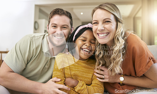 Image of Family, adoption and happiness portrait with foster child, mother and father together for love, care and trust together on living room couch. Smile, support and laughing man, woman and girl bonding