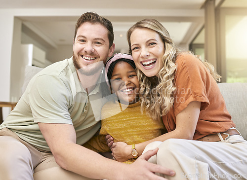 Image of Adoption, love and parents with a hug for child on the sofa in the living room of family home. Happy, care and portrait of African girl kid with affection from mother and father in interracial house