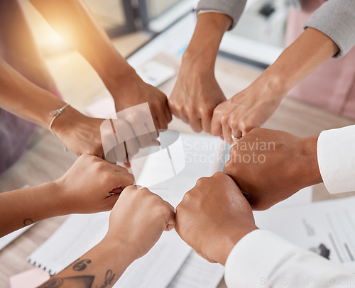 Image of Teamwork, support and circle of hands in fist of business people in meeting with documents. Diversity, collaboration and aerial of workers fists for motivation, community and growth in workplace