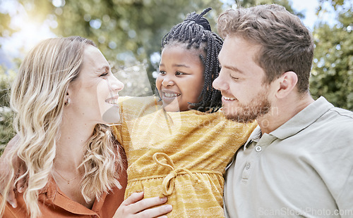 Image of Adoption, hug and child with parents in a park with love, smile and happy for interracial family. Happiness, natural and African girl kid hugging her mother and father in a backyard or garden