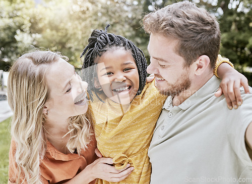 Image of Happy family, parents and adoption kid at park, garden and nature for fun, bonding and quality time with love, care and happiness together. Smile black kid hug foster mom, dad and diversity people