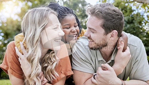 Image of Happy family, adoption and child hug parents while relax together, bonding and enjoy outdoor quality time on park field. Love, parenthood and diversity family in nature for peace, freedom and calm