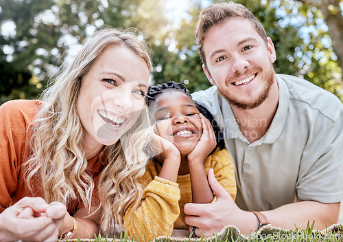 Image of Adoption, mother and father in nature as a happy family relaxing on a picnic bonding in summer holidays. Interracial, portrait and healthy mom with dad enjoying a lovely vacation with a girl child