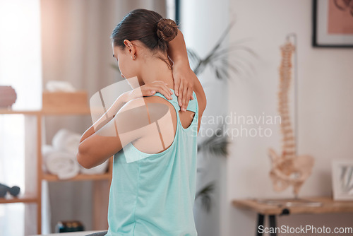 Image of Chiropractor, physiotherapy and injury with a woman client stretching in an office for movement or mobility. Rehabilitation, recovery and pain with a female patient at the physio for healing