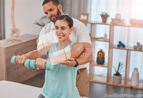 Image of Physiotherapy, exercise and dumbbells with a man therapist and woman client in a rehabilitation session. Fitness, health and consulting with a female patient in recovery training with a male physio