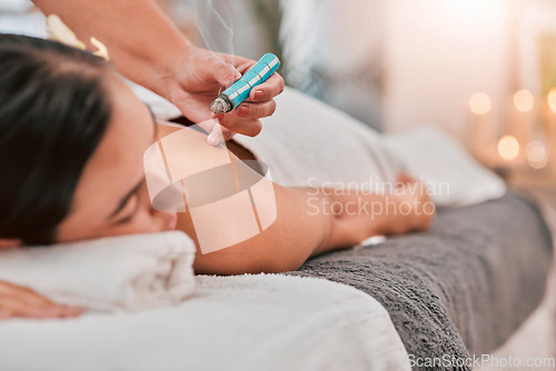 Image of Aromatherapy, relax and spa with a woman client on a massage bed for moxibustion treatment. Skincare, luxury and wellness with a female customer in a health center to relax for natural care