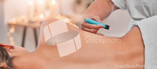 Image of Spa, heat acupuncture and woman relaxing for a back massage using moxibustion or alternative medicine. Healing, acupuncturist and massage therapy with physical therapy on patient with sen treatment