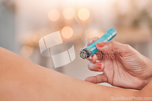 Image of Hands, aromatherapy and relax with a massage therapist and client using moxibustion therapy in a wellness center. Spa, health and luxury with a masseuse massaging a woman customer relaxation