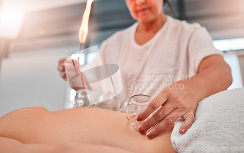 Image of Relax, cupping massage and man at a spa for wellness, healing and holistic therapy with woman therapist. Hand cup therapy and fire treatment on client at resort for toxins, blood and circulation