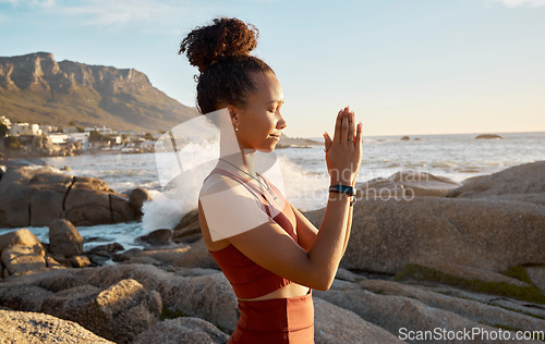 Image of Woman, prayer hands or meditation by sunrise beach, ocean or sea water for relax fitness, workout or exercise in spiritual wellness. Yogi, praying mudra or zen person in mind training or nature peace