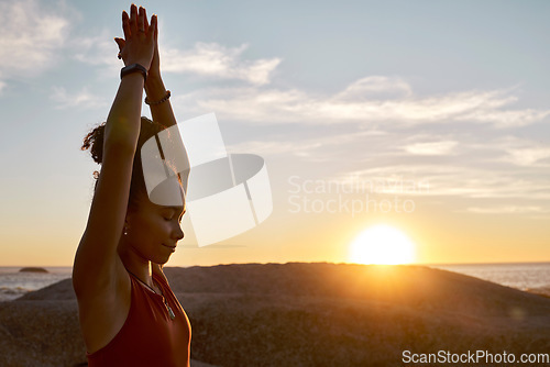 Image of Yoga, sunset and nature with black woman at beach for meditation, zen exercise and prayer, hands for calm and peace. Fitness, woman outdoor for workout for healthy lifestyle, energy and mindfulness