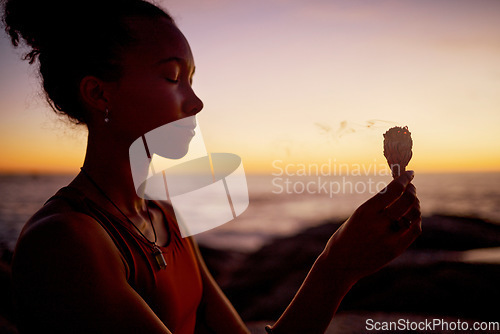 Image of Sunset meditation, woman relax in by beach and ocean for zen peace focus, chakra wellness and mental health by the sea. Burning sage in nature, aromatherapy and spiritual mindfulness health exercise