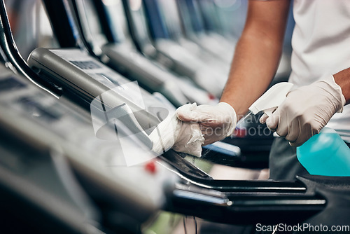 Image of Cleaning, treadmill and sanitizing equipment in gym for bacteria, germs or protection from covid. Disinfection, sanitizer and closeup of cleaner wiping running machine for fitness in sports center.