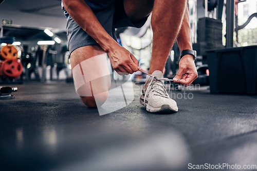 Image of Hands, gym and man tie shoes preparing for training, running or exercise. Sports, fitness or male athlete in health studio getting ready for cardio, workout or bodybuilding practice in fitness center
