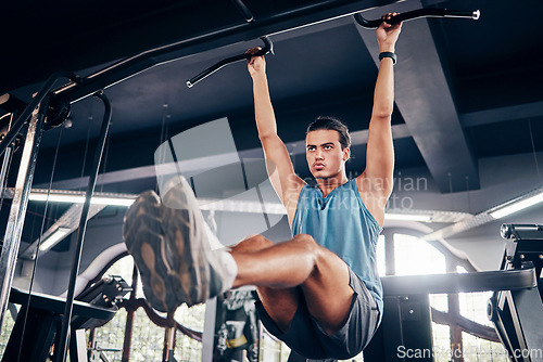 Image of Fitness, exercise and weight training with a man at gym for a workout for focus and strong body and mindset for health and wellness. Bodybuilder or athlete using pull up bar for power and muscle