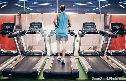 Image of Fitness, man and running on treadmill at the gym for healthy cardio, exercise or weight loss workout. Active sports male runner training or exercising on stationary equipment for a run at health club