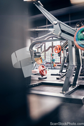 Image of Gym interior, fitness and exercise with gym equipment and weightlifting for body training, health and wellness. Weights, muscle and strong for cardio and endurance with metal and steel for workout.