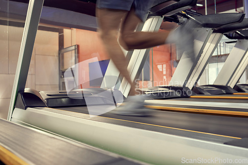 Image of Running, fast and legs of a man on the treadmill for fitness, training and motivation in the gym. Energy, power and runner on equipment at a club for cardio exercise, workout and sports health