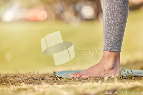 Image of Woman feet, mat and yoga on grass, park and exercise, meditation and spiritual wellness in nature for zen. Female, pilates or cardio person with workout training for peace, calm and healthy lifestyle