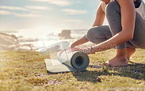 Image of Woman, roll yoga mat and beach for meditation, outdoor and peace to relax or for wellness. African American female, healthy lady and grass start pilates, fitness and exercise at peaceful seaside