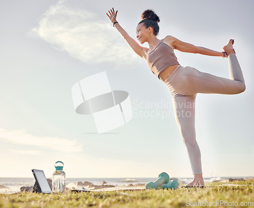 Image of Yoga, tablet and nature with a woman athlete by the ocean for inner peace, wellness or zen exercise. Fitness, health and technology with a female yogi enjoying the view while stretching for training