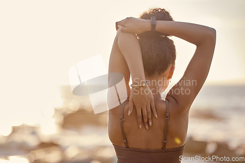 Image of Black woman, stretching and back at beach, for training and exercise for wellness, health and fitness. Bokeh, African American girl and healthy female doing workout, healthy and flexibility in summer