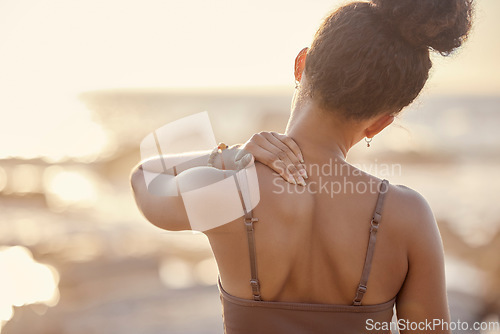 Image of Woman, back or neck pain in nature fitness, beach workout or sunset training and anatomy crisis, muscle stress or burnout. Runner, sports athlete or shoulder injury in sunrise exercise by ocean sea