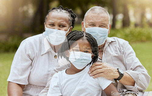 Image of Family portrait, covid and face mask outdoor at nature park with child and grandparents together on picnic for love, care and summer bonding. Man, woman and girl with covid 19 safety compliance